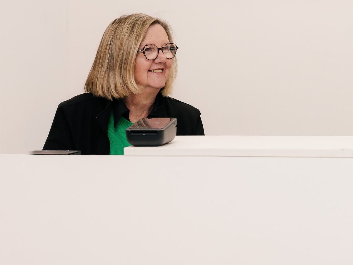 Kim Hando at the counter of the Comfort First and First Aid Distributions store in East Bendigo